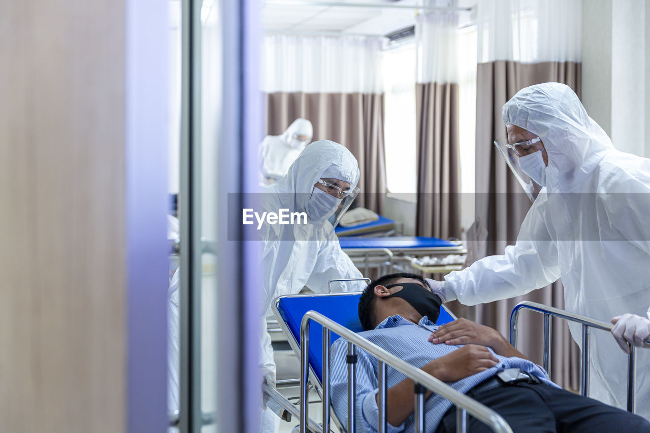 Doctors and staff taking the patient to the emergency room to check for viruses during the covid