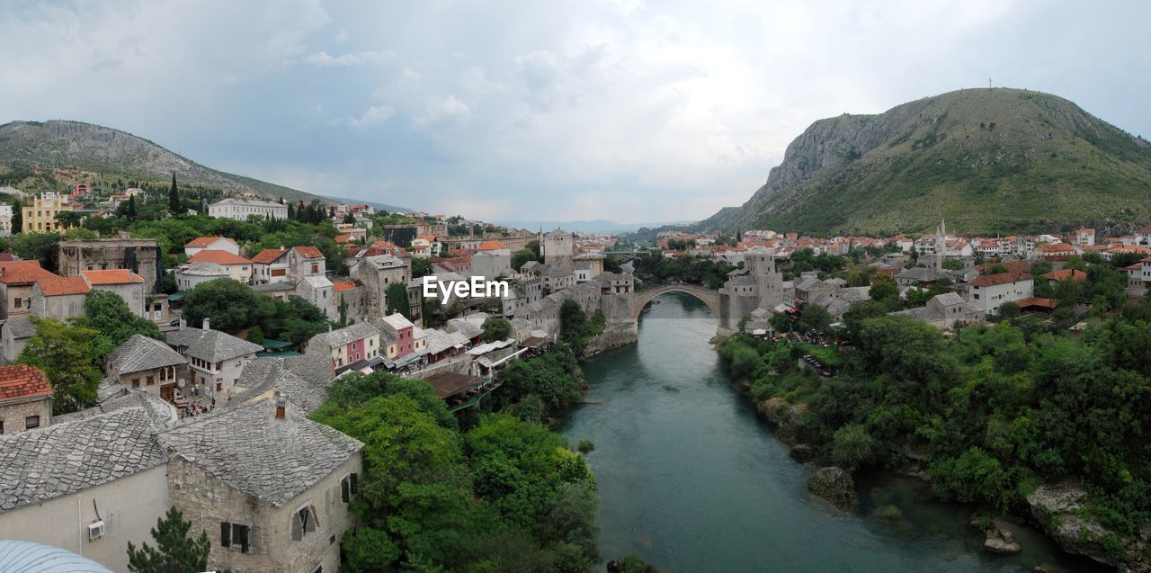 Town by mountains against sky