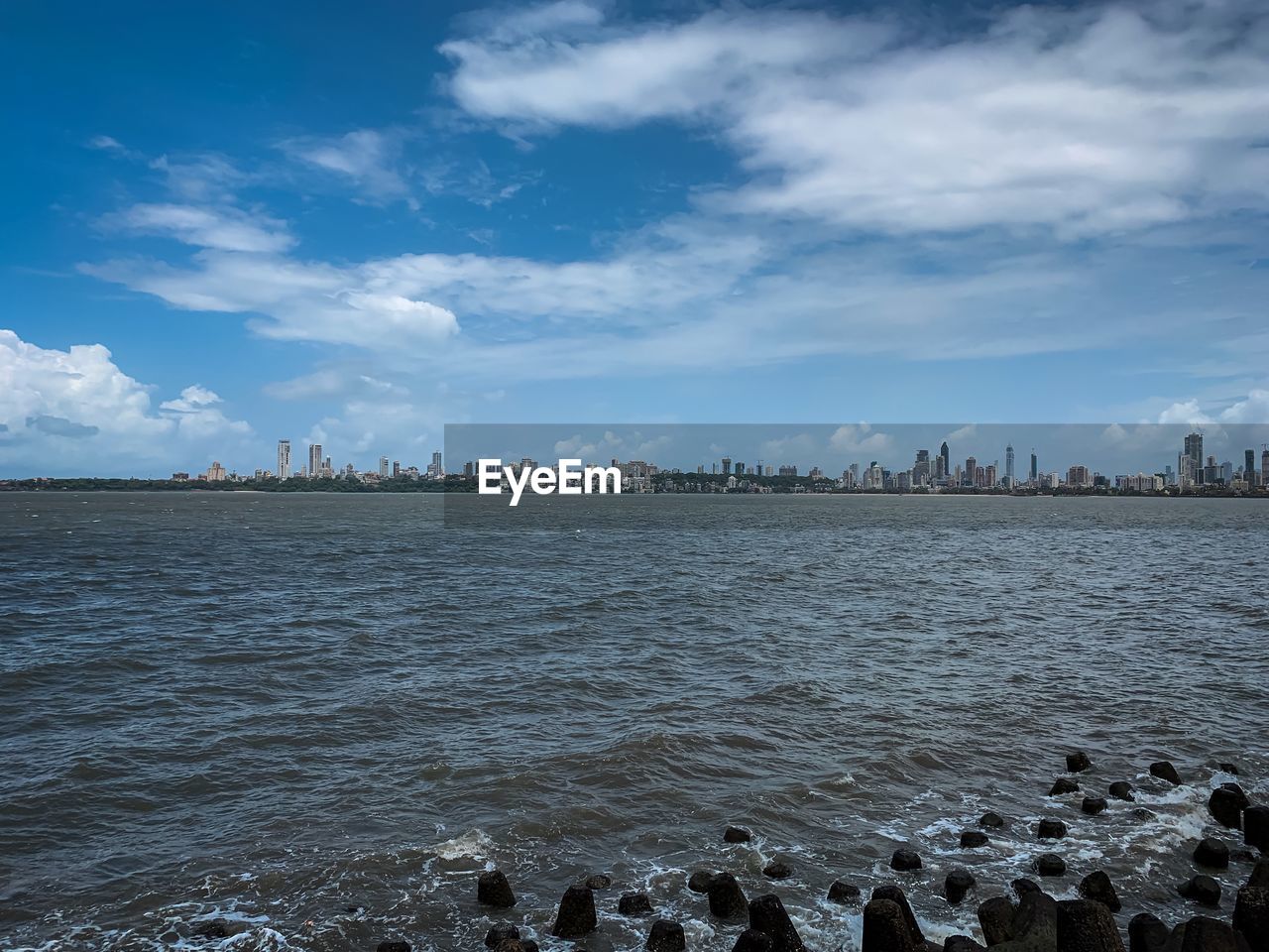 SCENIC VIEW OF SEA BY CITY AGAINST SKY