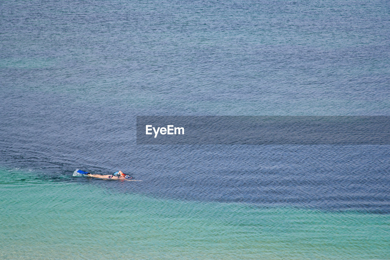 High angle view of woman swimming in sea