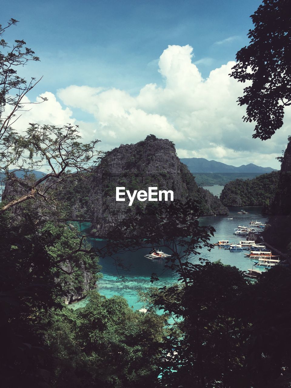 Scenic view of lake by mountains against sky