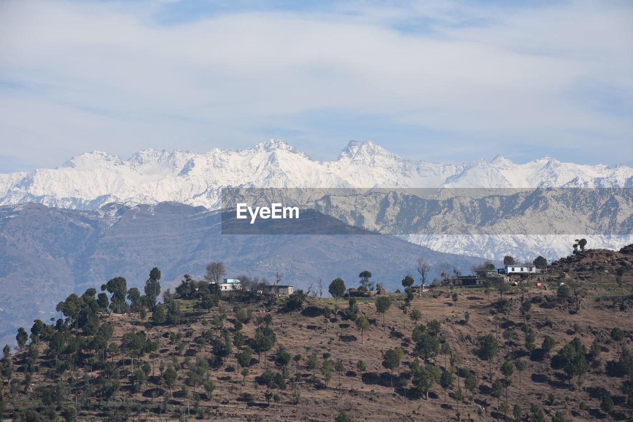 Scenic view of landscape and mountains against sky