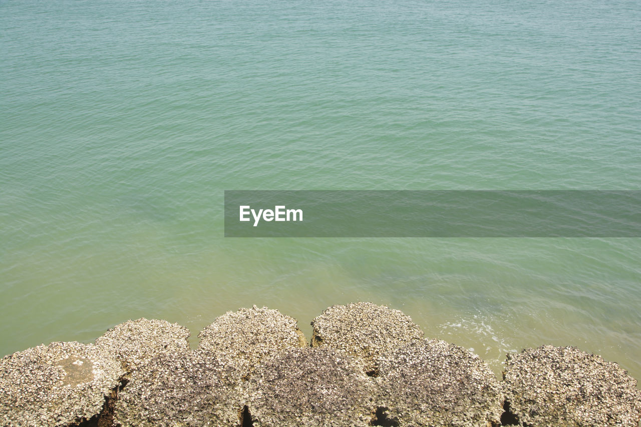 water, sea, shore, beach, beauty in nature, tranquility, land, high angle view, nature, coast, sand, day, ocean, tranquil scene, no people, scenics - nature, wave, rock, horizon, body of water, outdoors, sunlight, idyllic, rippled