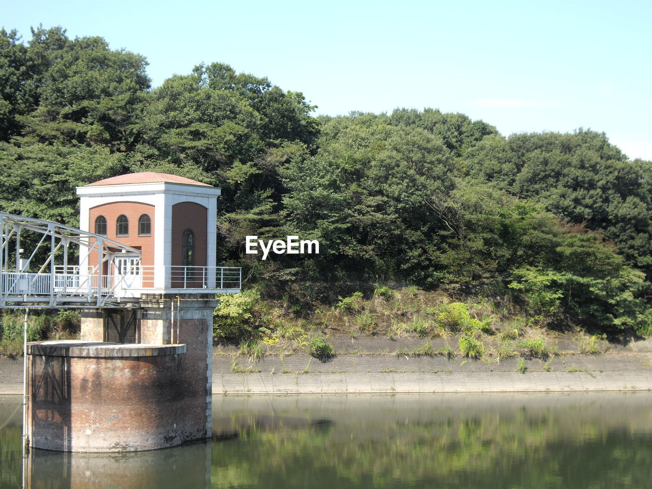 Built structure by lake against sky