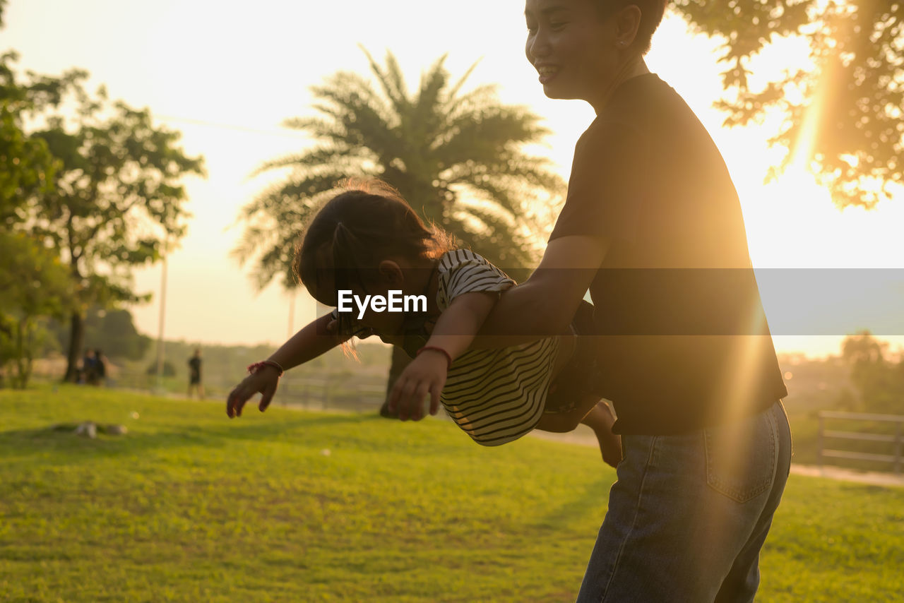 side view of young man sitting on field