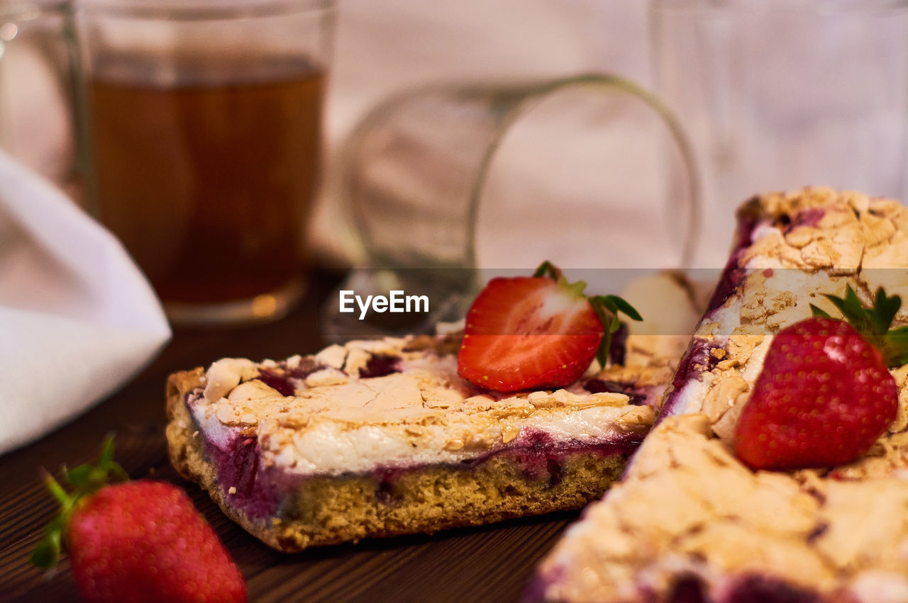 CLOSE-UP OF BREAD WITH FRUITS AND TABLE