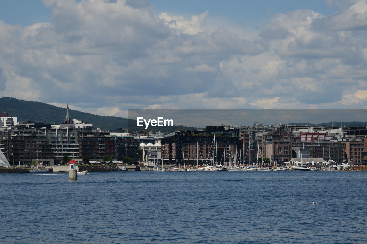 Sea against buildings in city