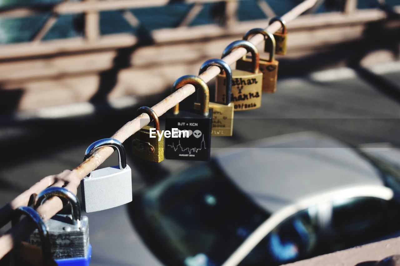 CLOSE-UP OF PADLOCKS ON METAL CHAIN