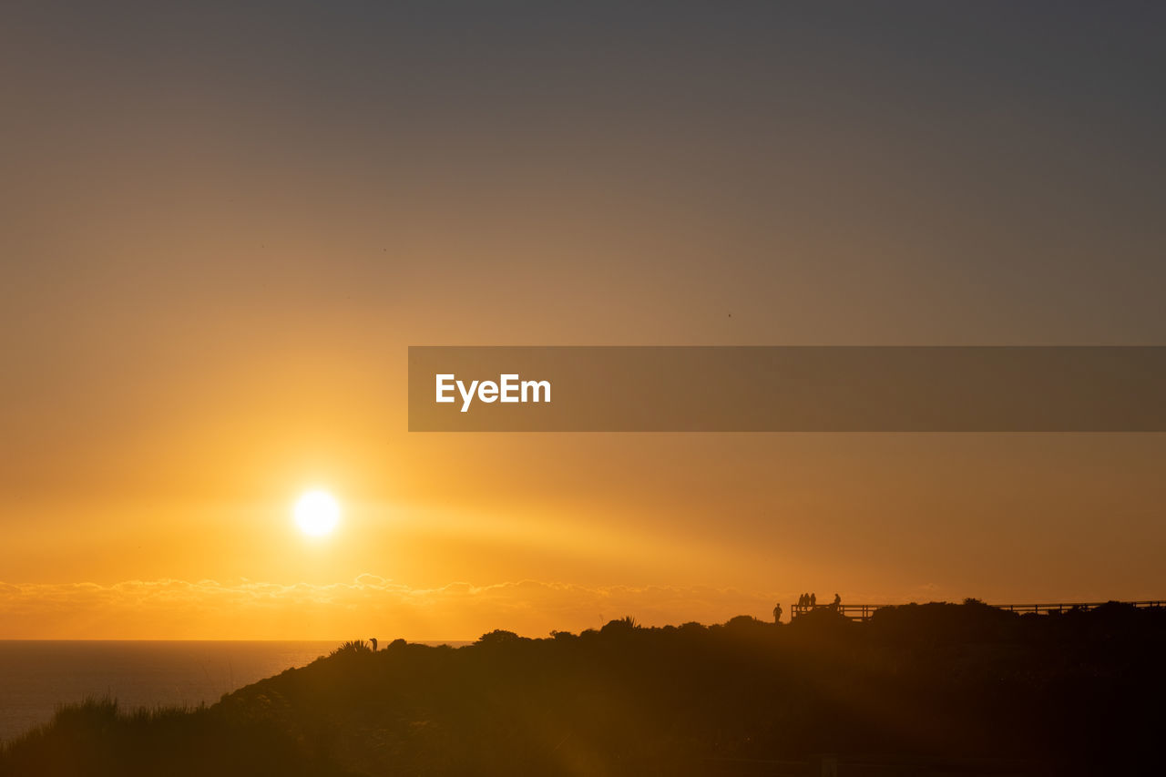 Scenic view of silhouette landscape against sky during sunset