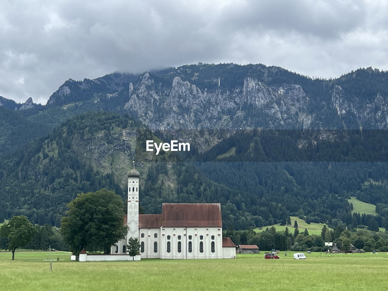 houses by mountain against sky