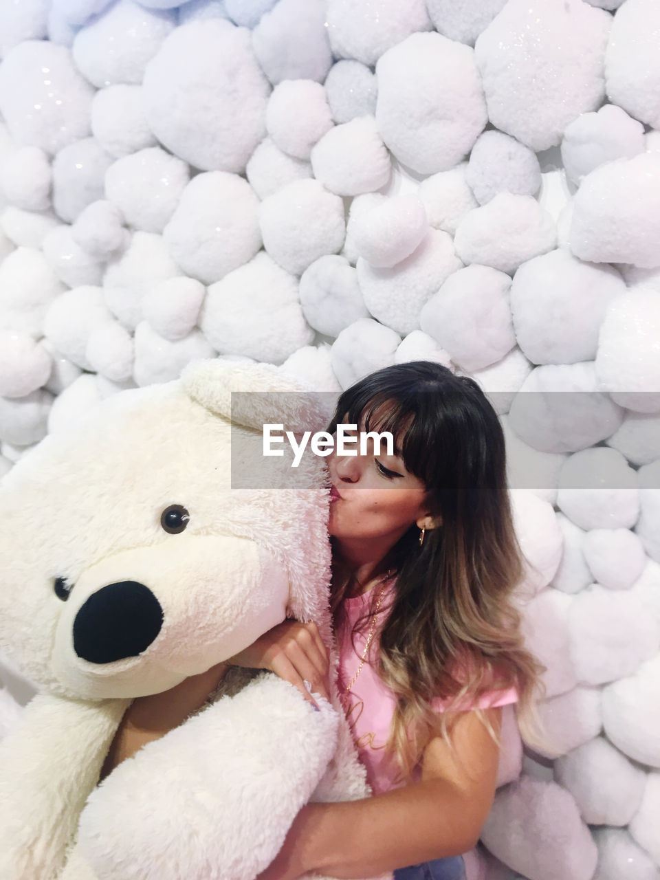 Young woman looking at toy in snow