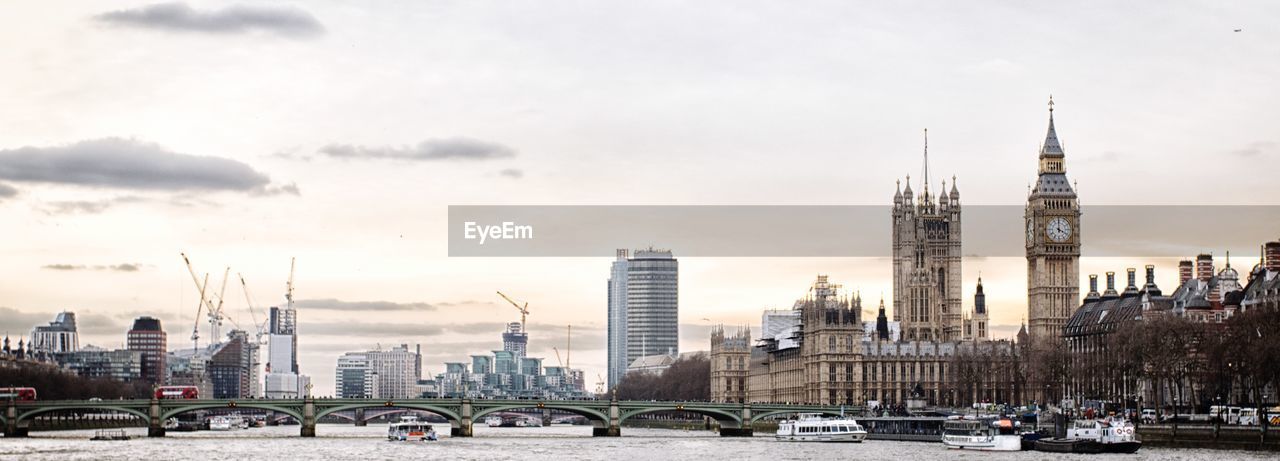 View of cityscape against cloudy sky