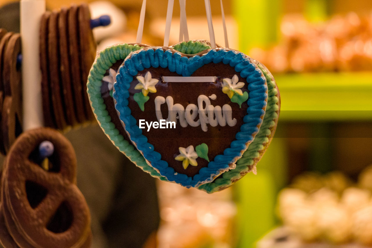 Close-up of heart shape sweet food hanging in store for sale