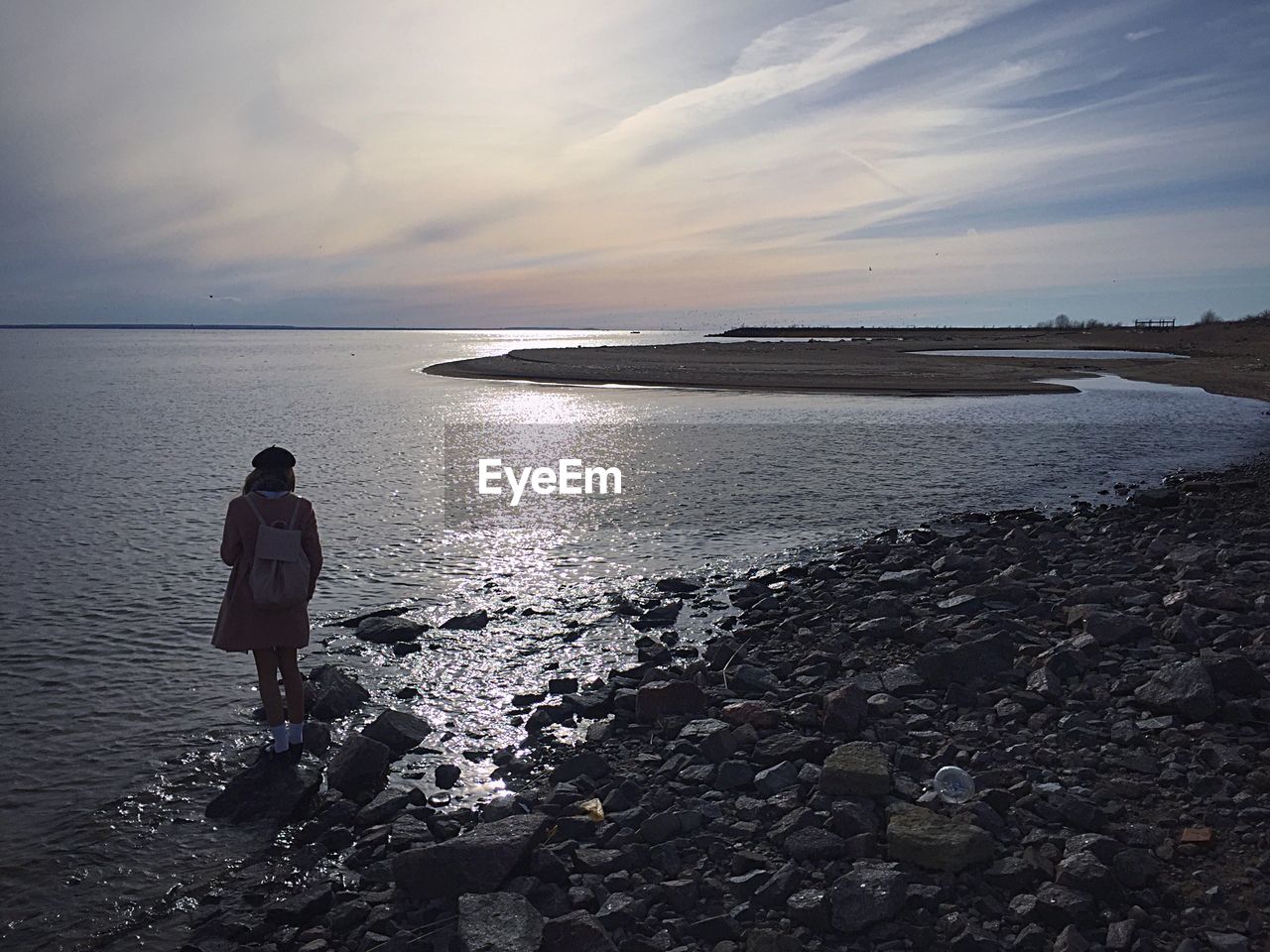 REAR VIEW OF PERSON PHOTOGRAPHING SEA AGAINST SKY