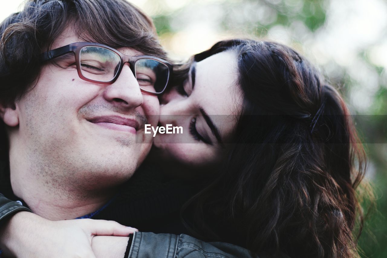 Close-up of woman kissing man