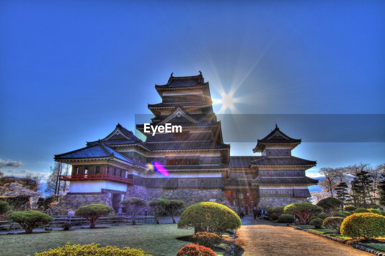 Low angle view of traditional structure against blue sky