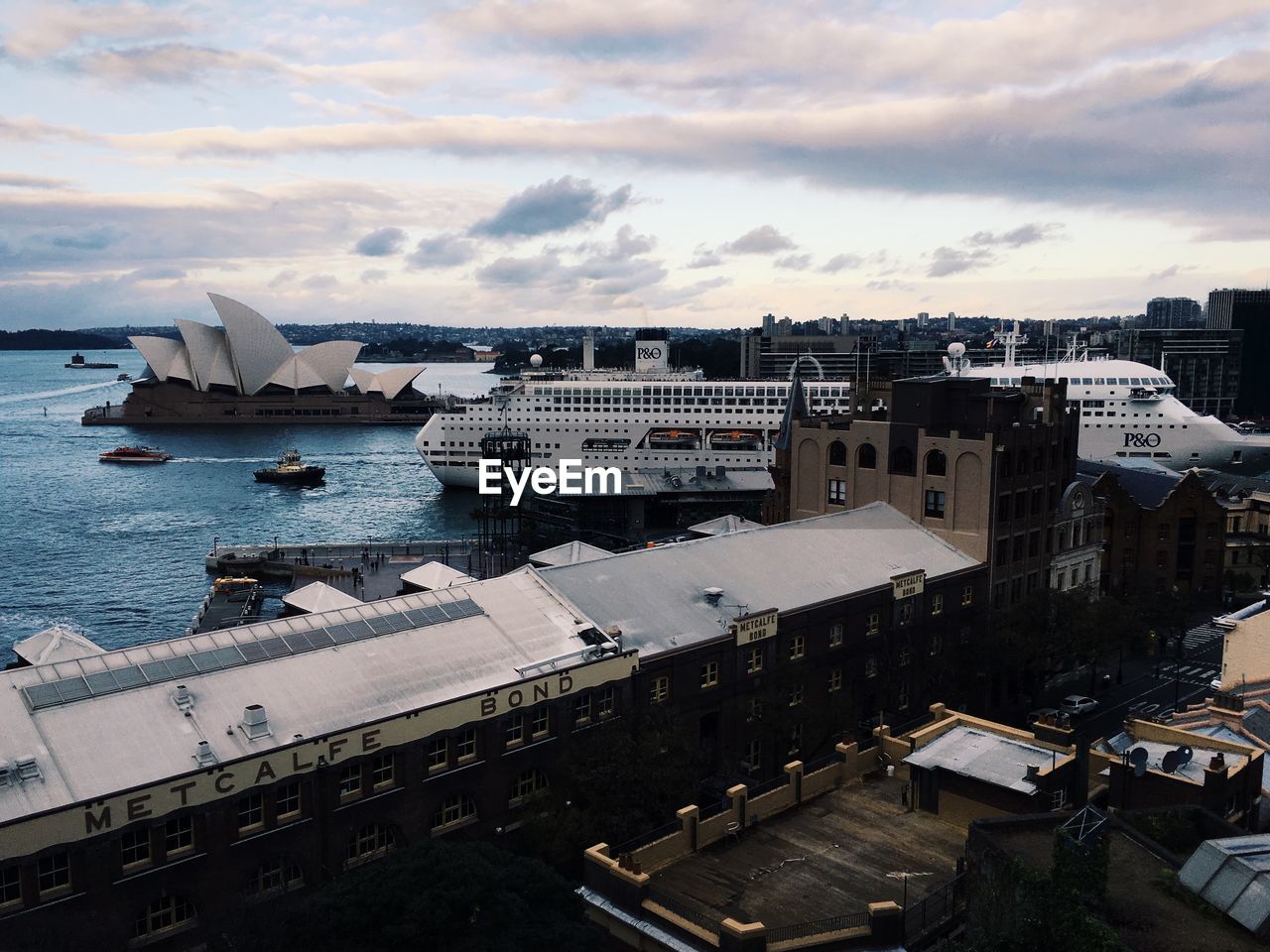 High angle view of cityscape by sea against sky