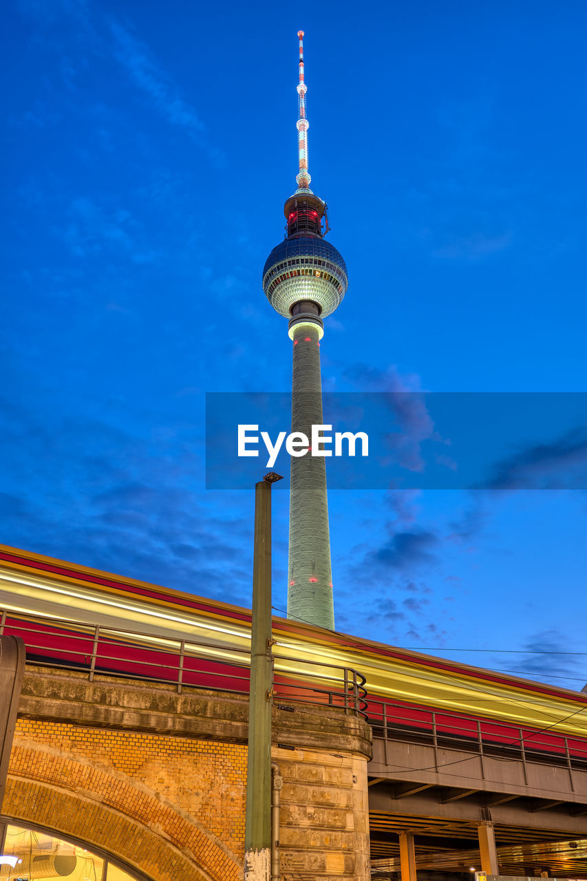 Commuter train and the famous television tower in berlin at dusk