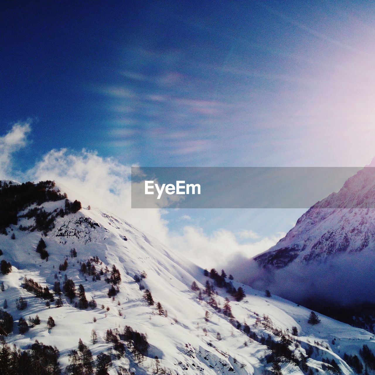 SCENIC VIEW OF SNOWCAPPED MOUNTAINS AGAINST SKY DURING WINTER