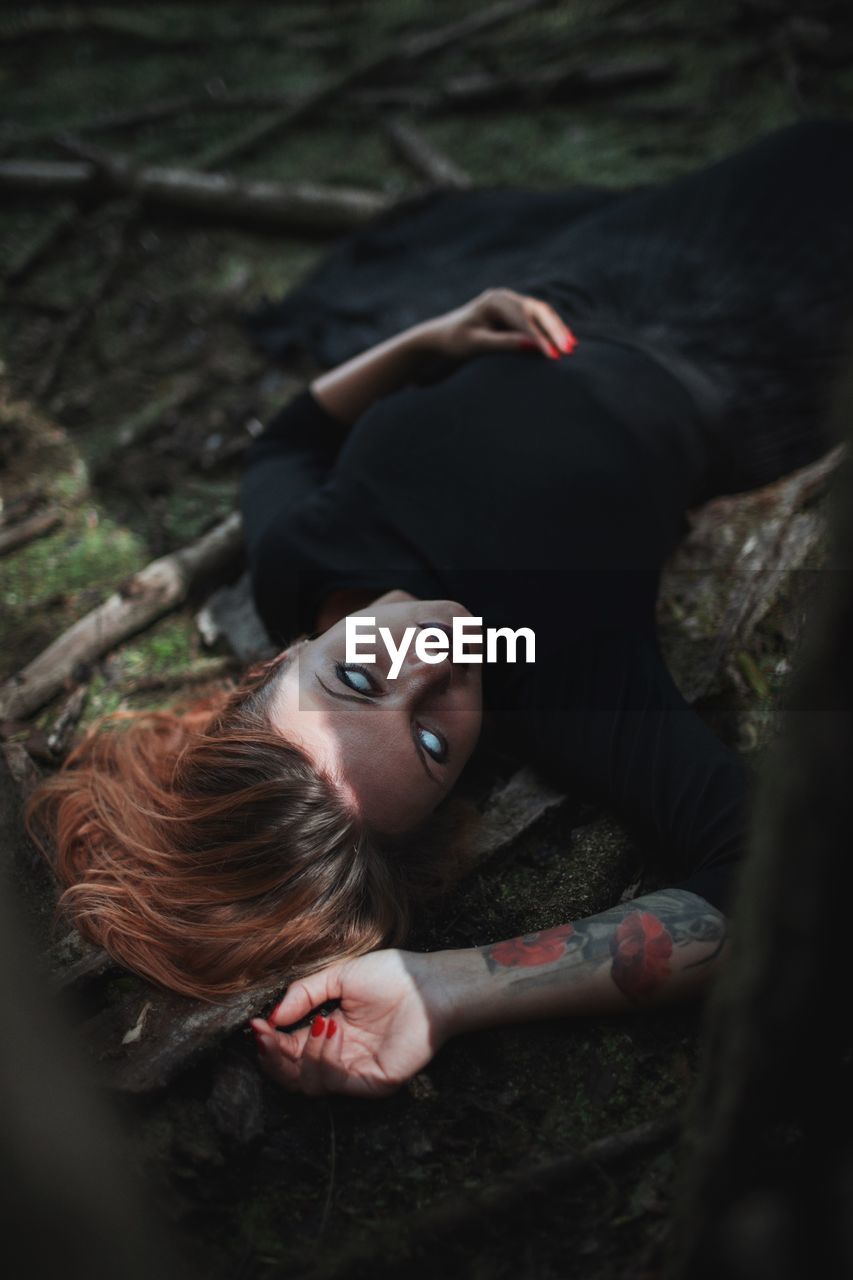Woman with blind eyes in forest