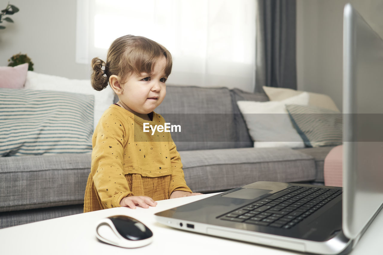 Adorable baby with a laptop