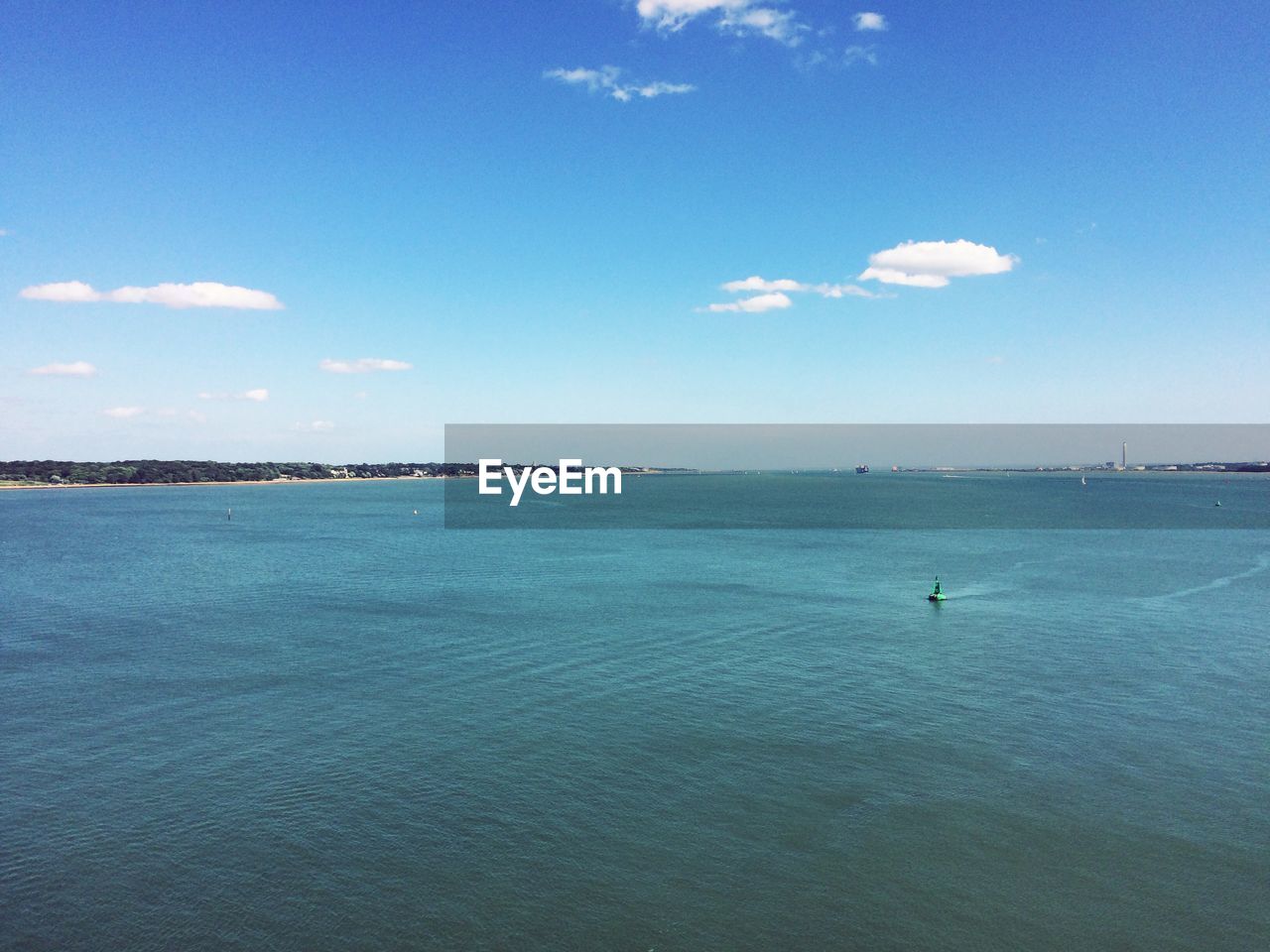 Scenic view of sea against blue sky