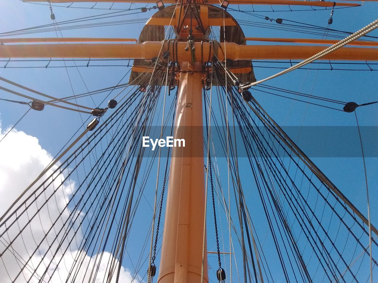 Low angle view of sailboat against blue sky