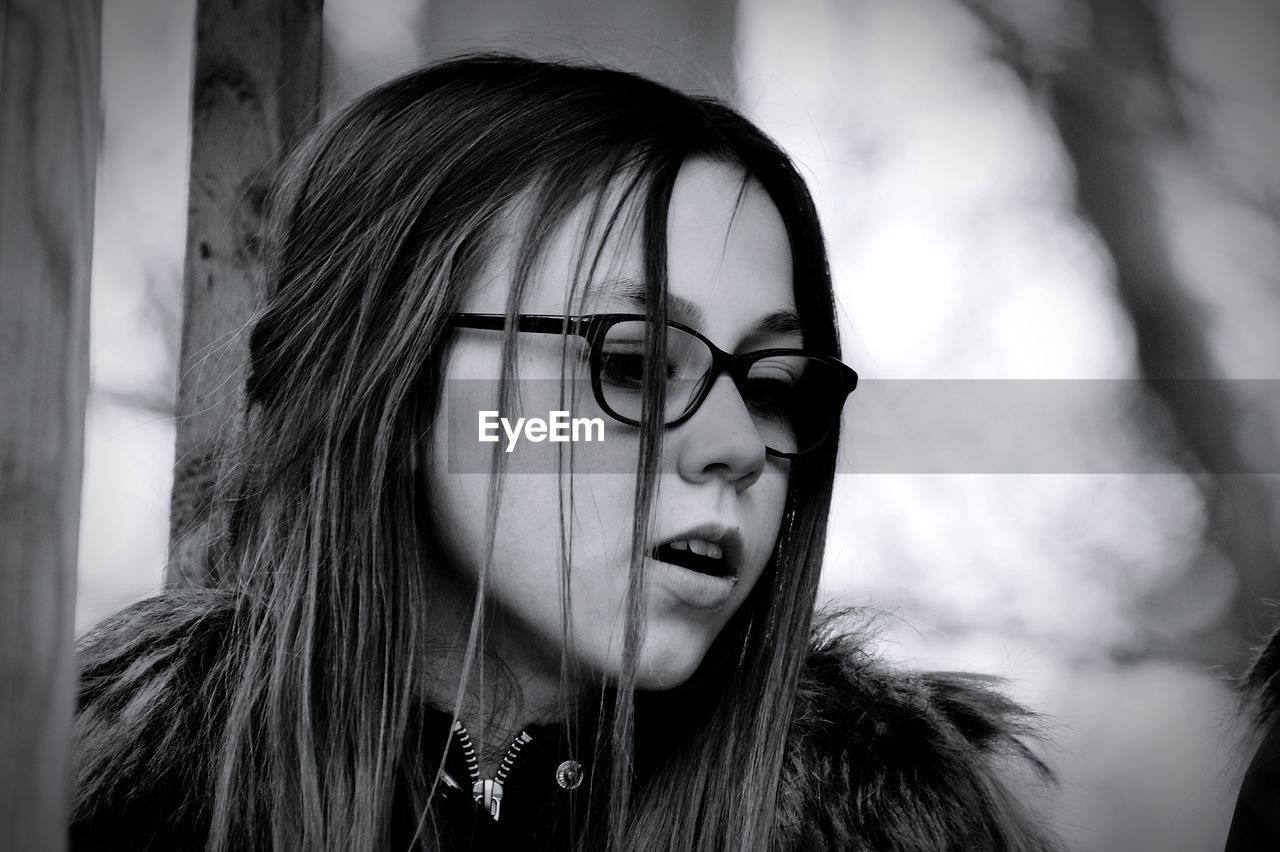 Thoughtful girl wearing eyeglasses looking away