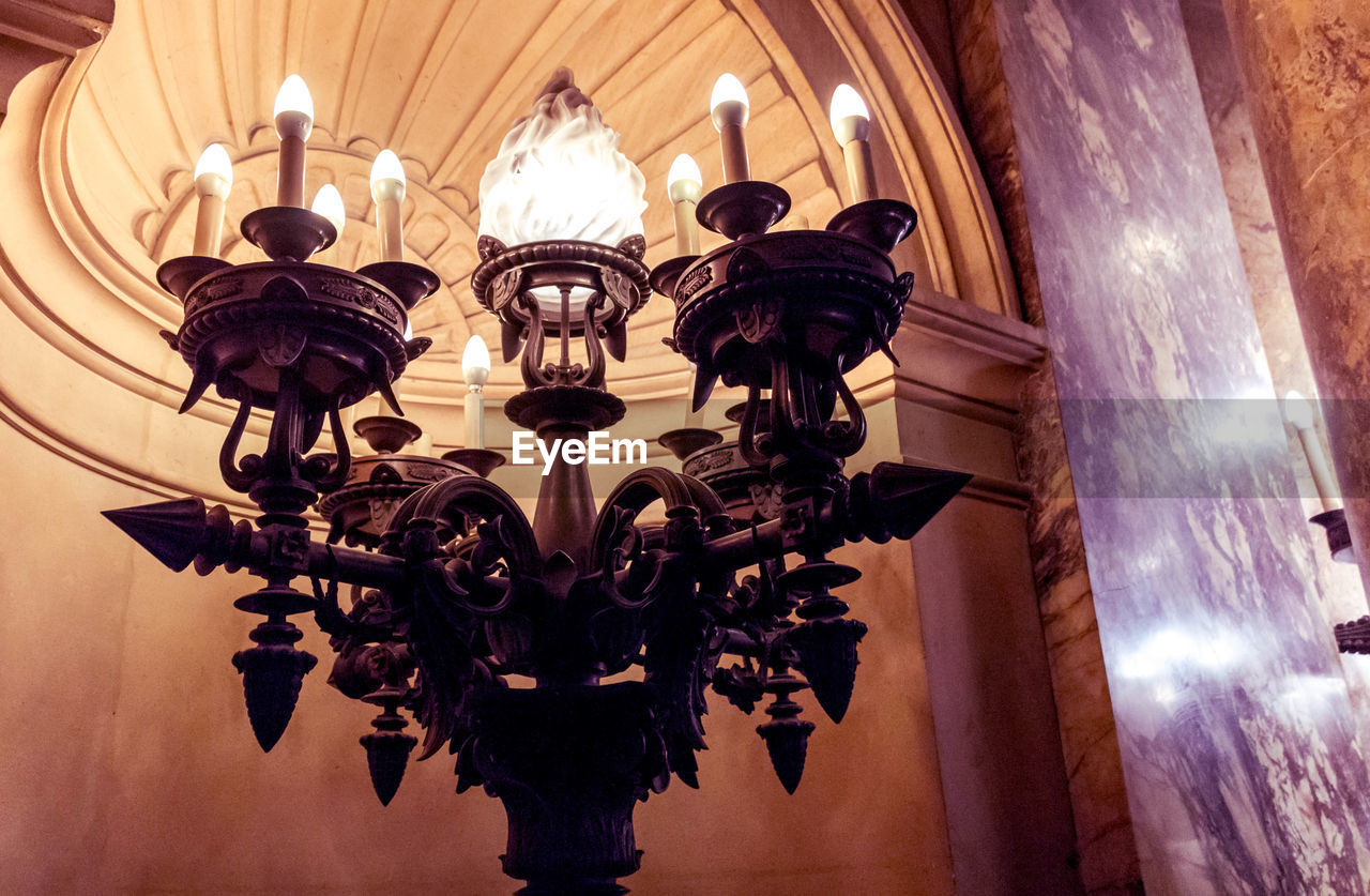 LOW ANGLE VIEW OF ILLUMINATED LIGHT BULBS HANGING