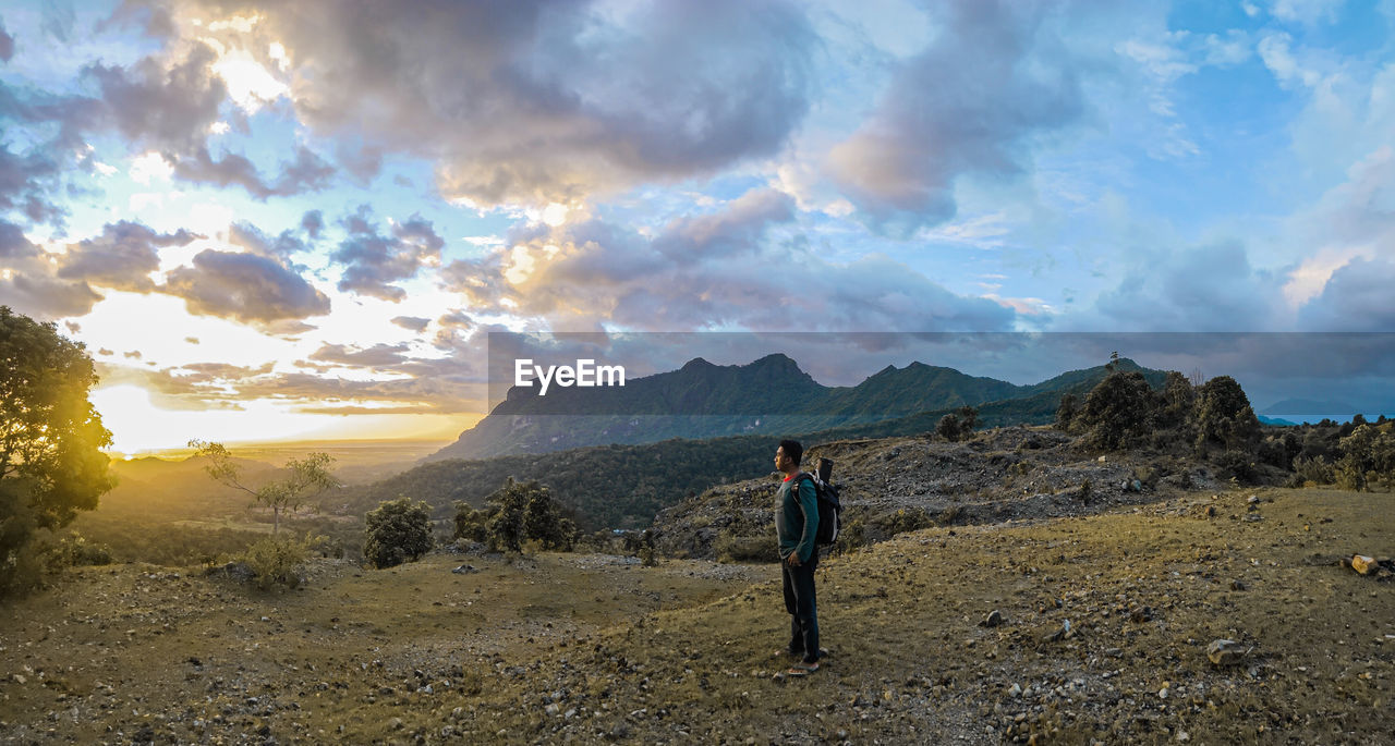 Man standing on mountain against sky