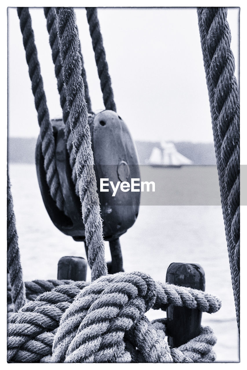 CLOSE-UP OF ROPES TIED ON WOODEN POST