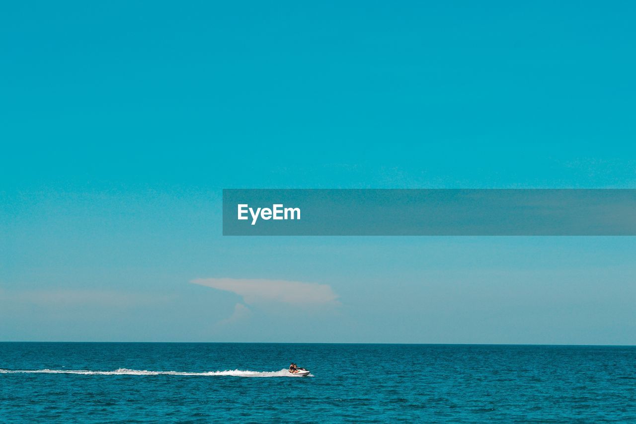 BOAT IN SEA AGAINST SKY