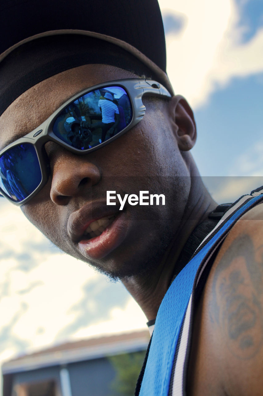 blue, portrait, sunglasses, fashion, adult, one person, headshot, glasses, men, day, close-up, vision care, goggles, sports, young adult, eyewear, lifestyles, outdoors, focus on foreground, leisure activity, person, clothing, nature, sky, sunlight, side view, cool attitude, looking, emotion