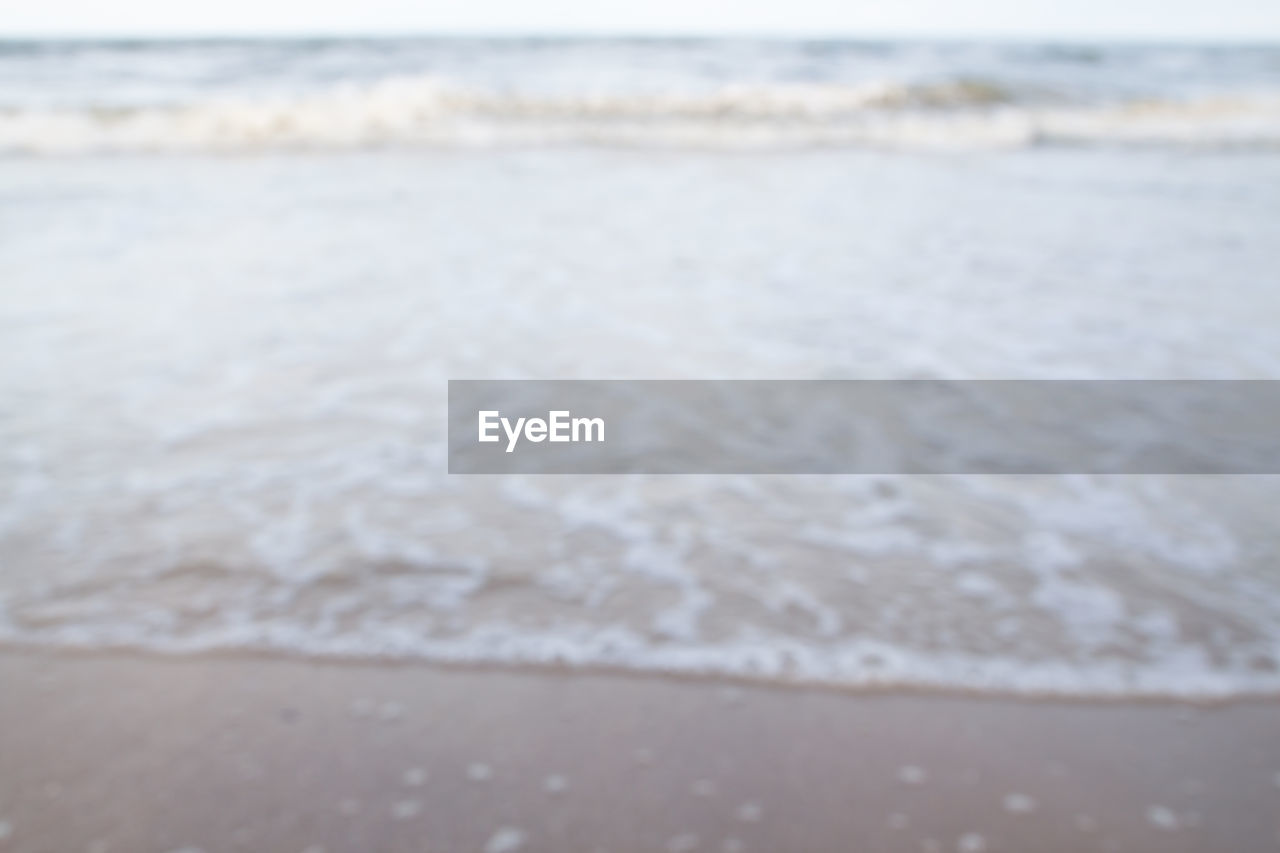 Defocused image of waves rushing towards shore