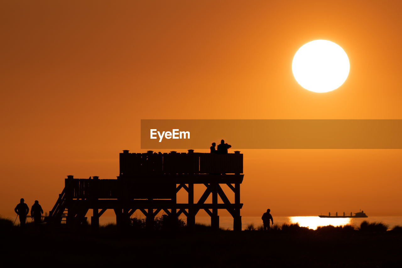 Silhouette of people on outlook while sunset