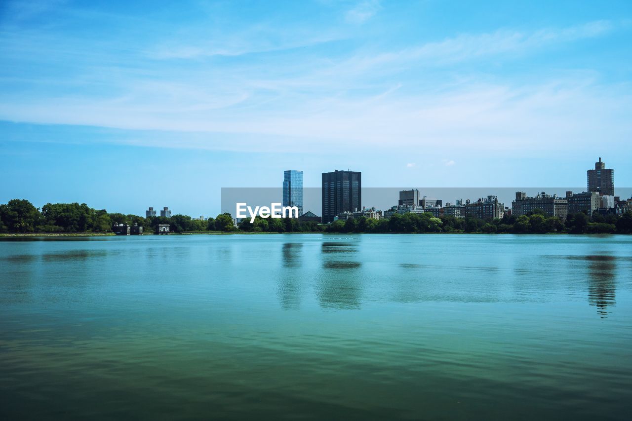 LAKE AND BUILDINGS AGAINST SKY