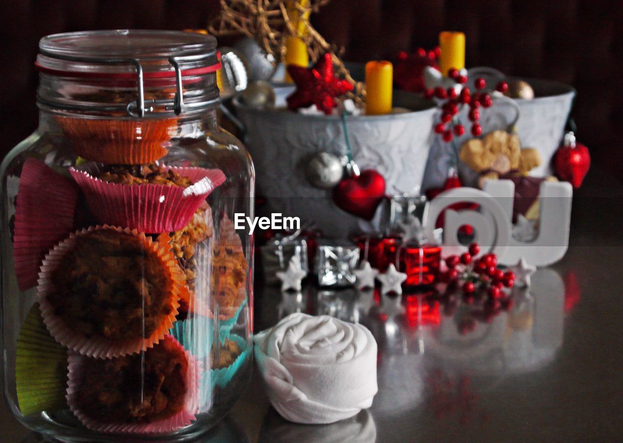 Close-up of cupcakes in jar by christmas decorations