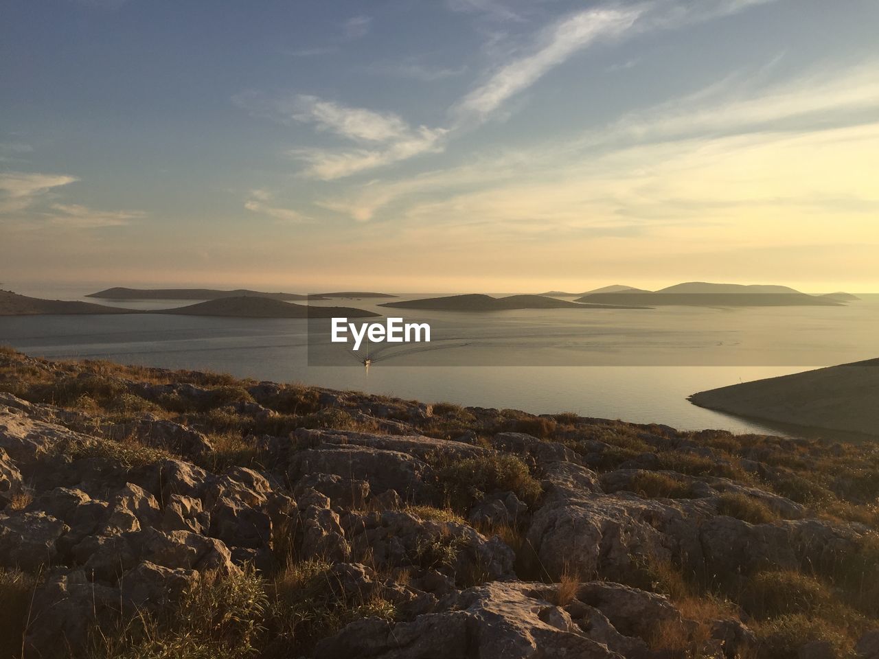 Scenic view of sea against sky seen from cliff during sunset