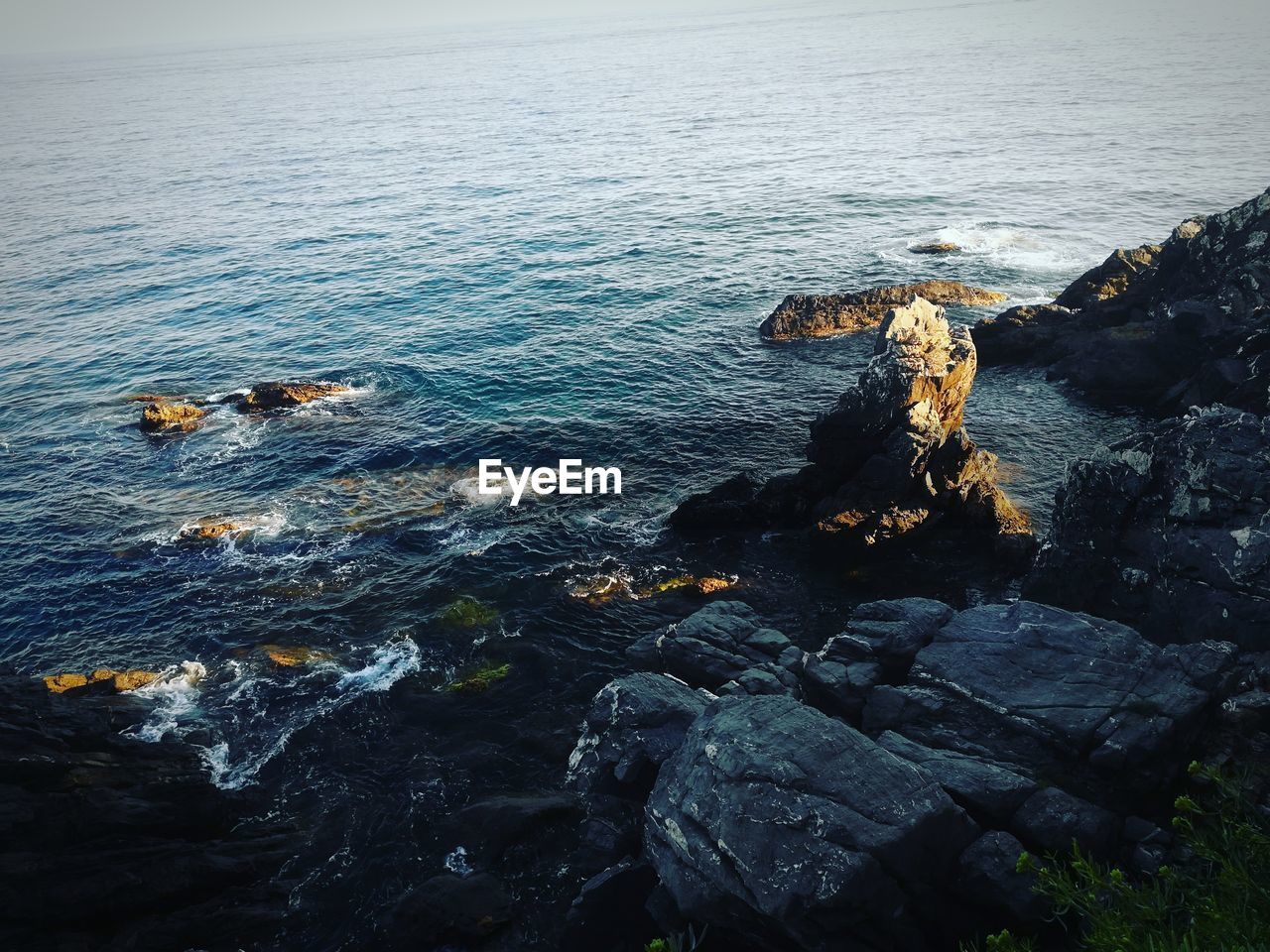 High angle view of rocks by sea