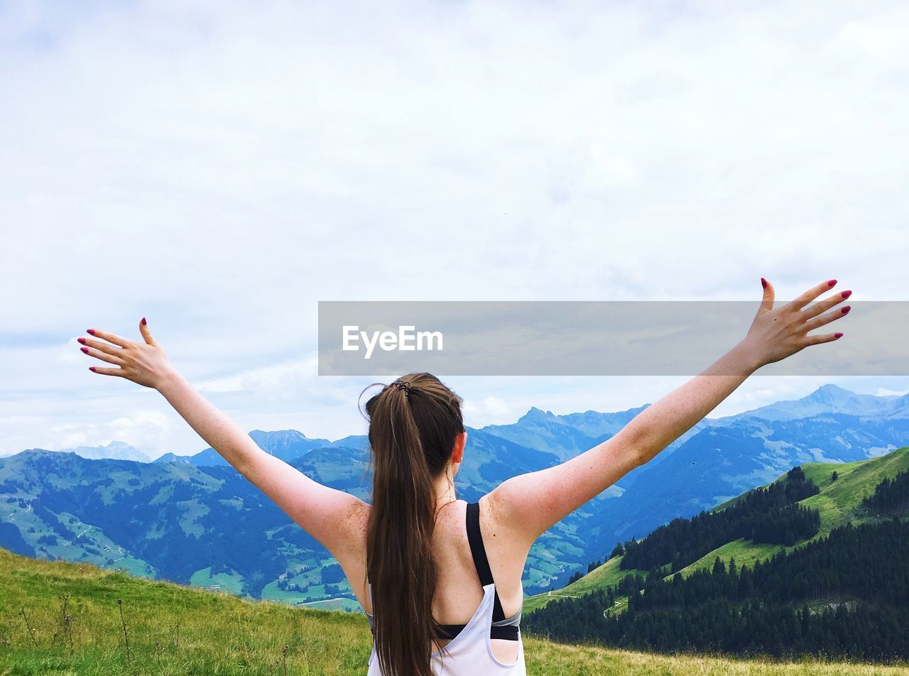 Rear view of woman standing on mountain