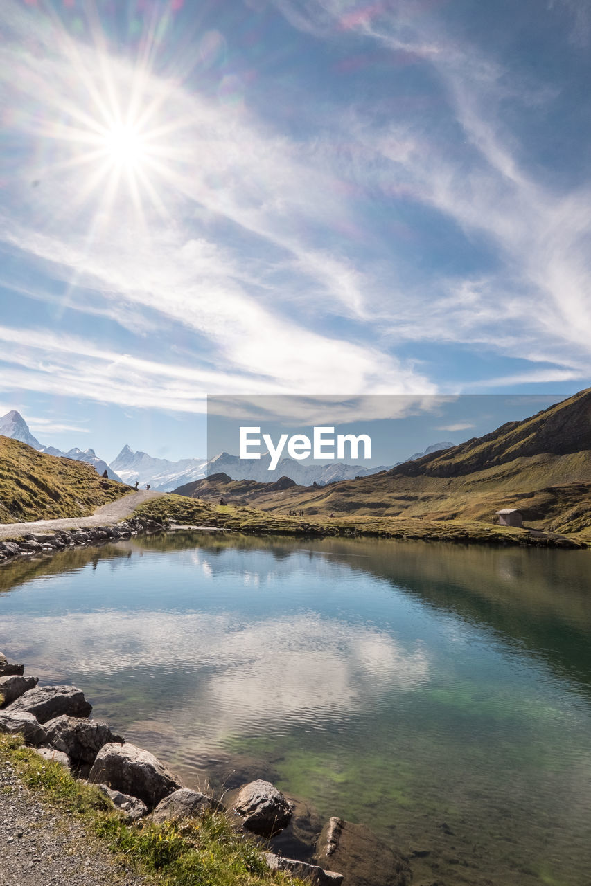 View of calm lake against cloudy sky