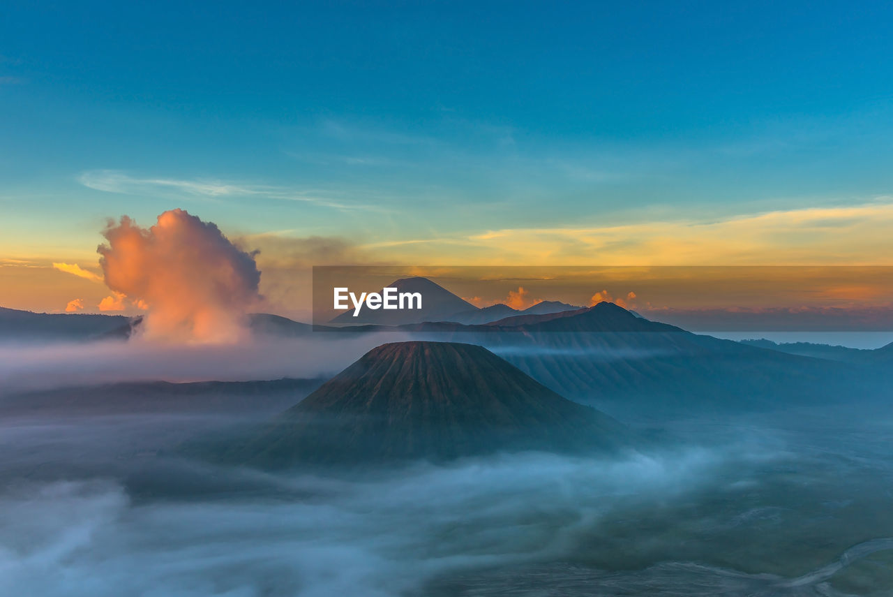 View of volcanic mountain against cloudy sky