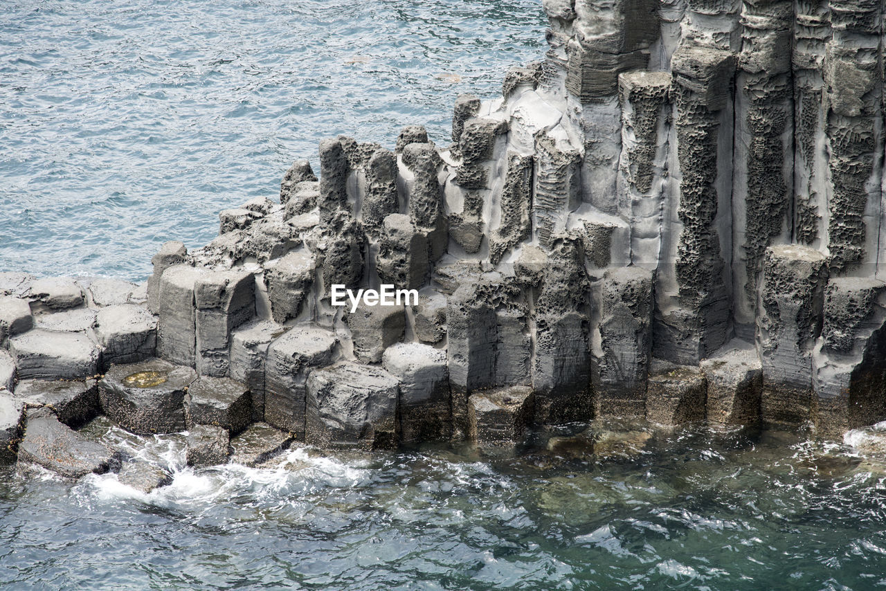 High angle view of sea by columnar jointing