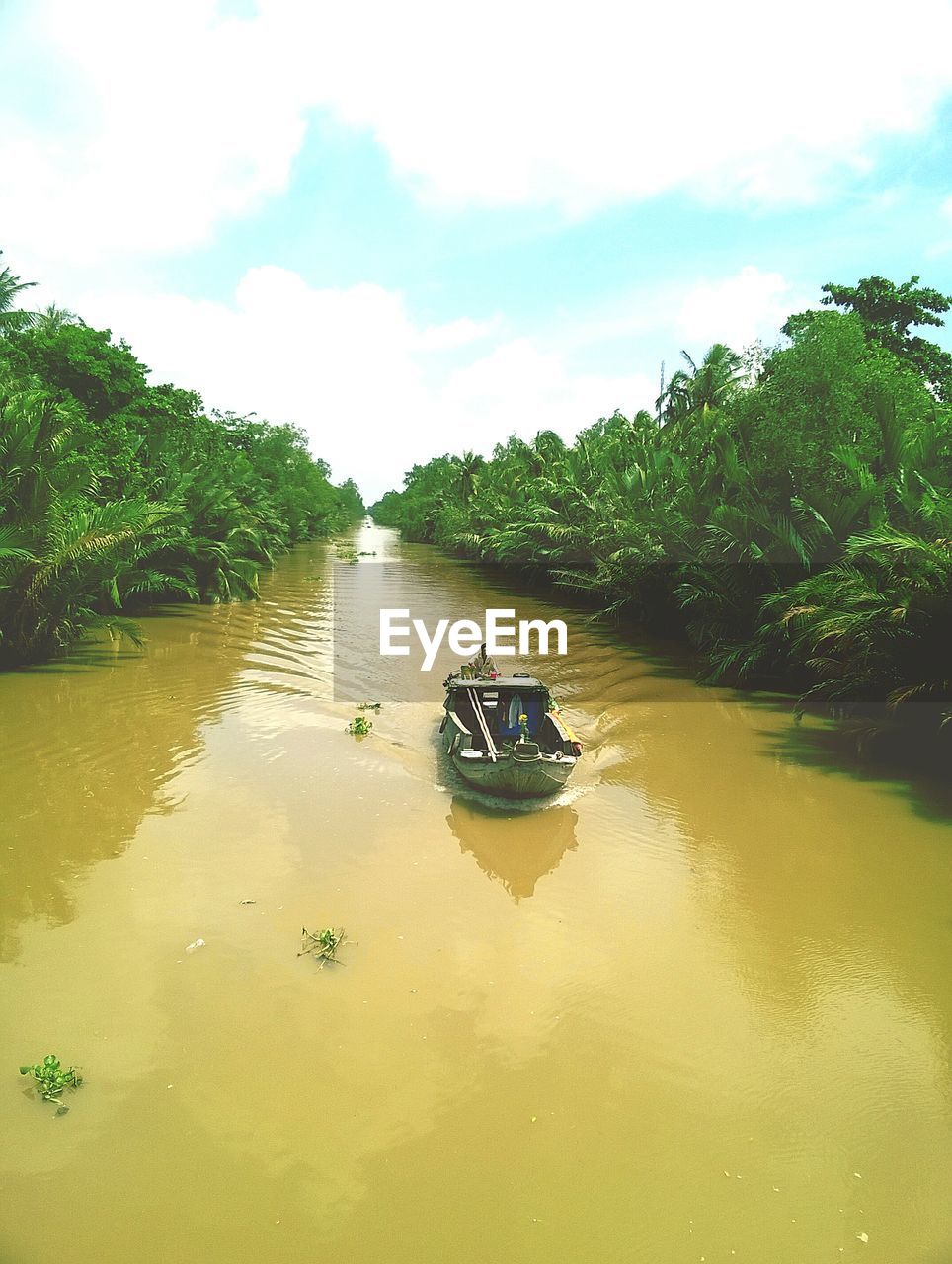 Boats in river with city in background