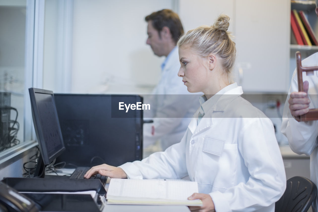 Young woman working on computer in lab