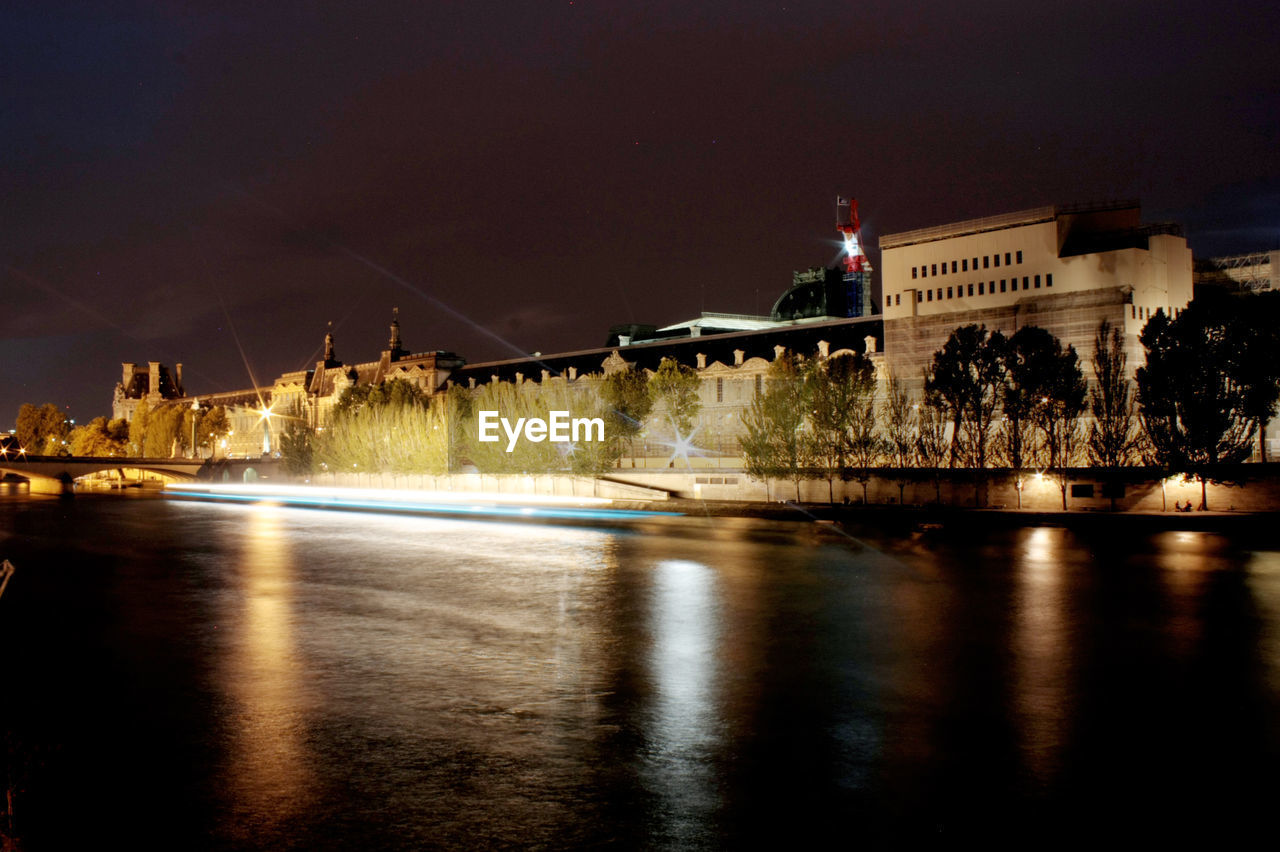 VIEW OF ILLUMINATED CITY AT NIGHT