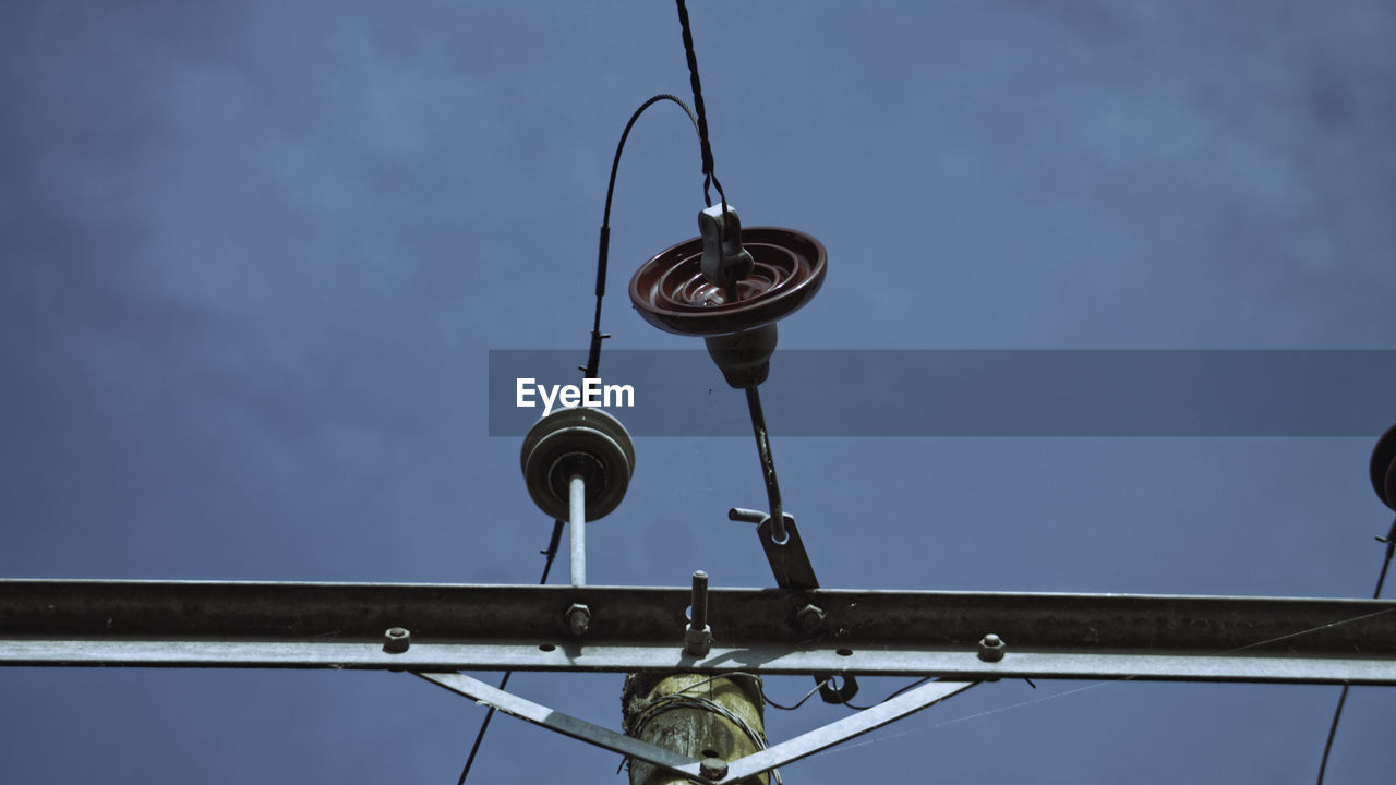 LOW ANGLE VIEW OF ELECTRIC LIGHT AGAINST SKY