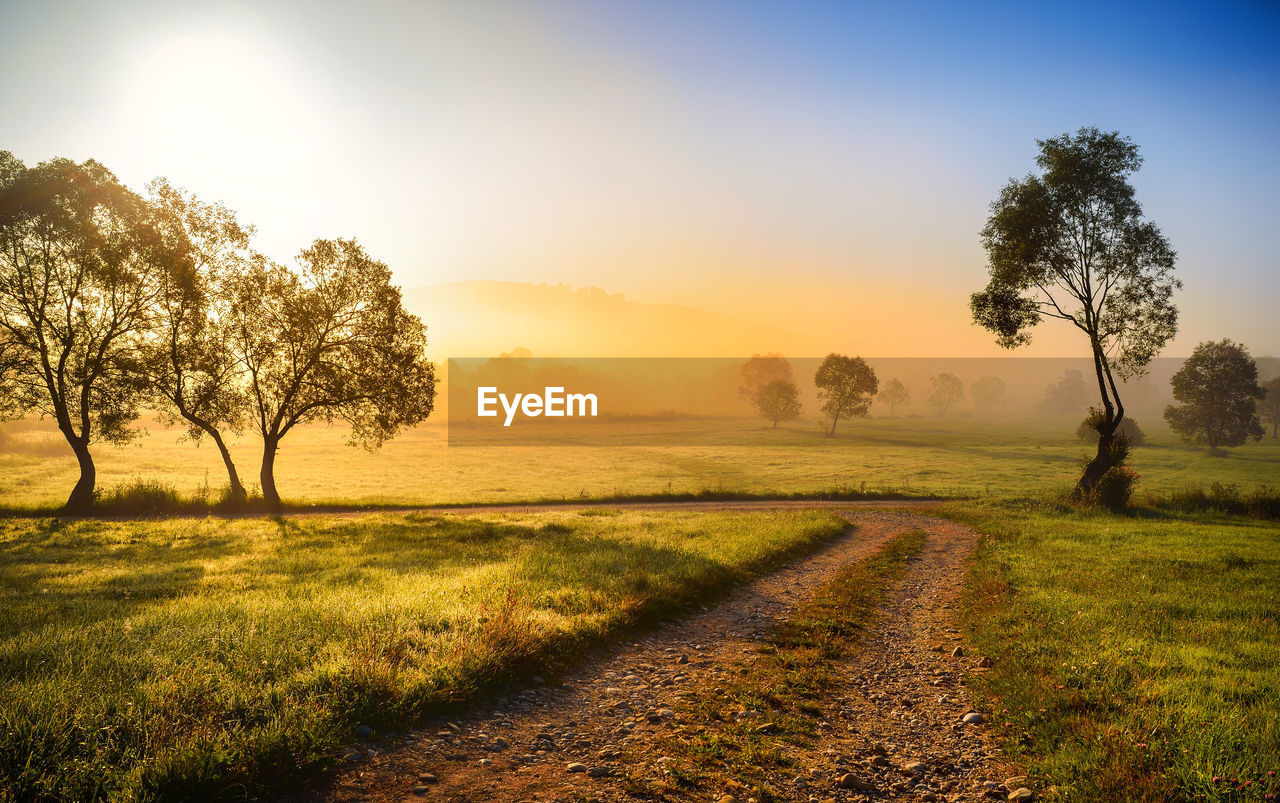 SCENIC VIEW OF LANDSCAPE AGAINST SKY DURING SUNSET