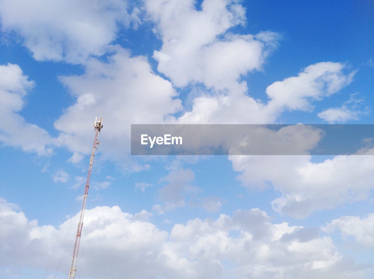 Low angle view of communications tower against sky