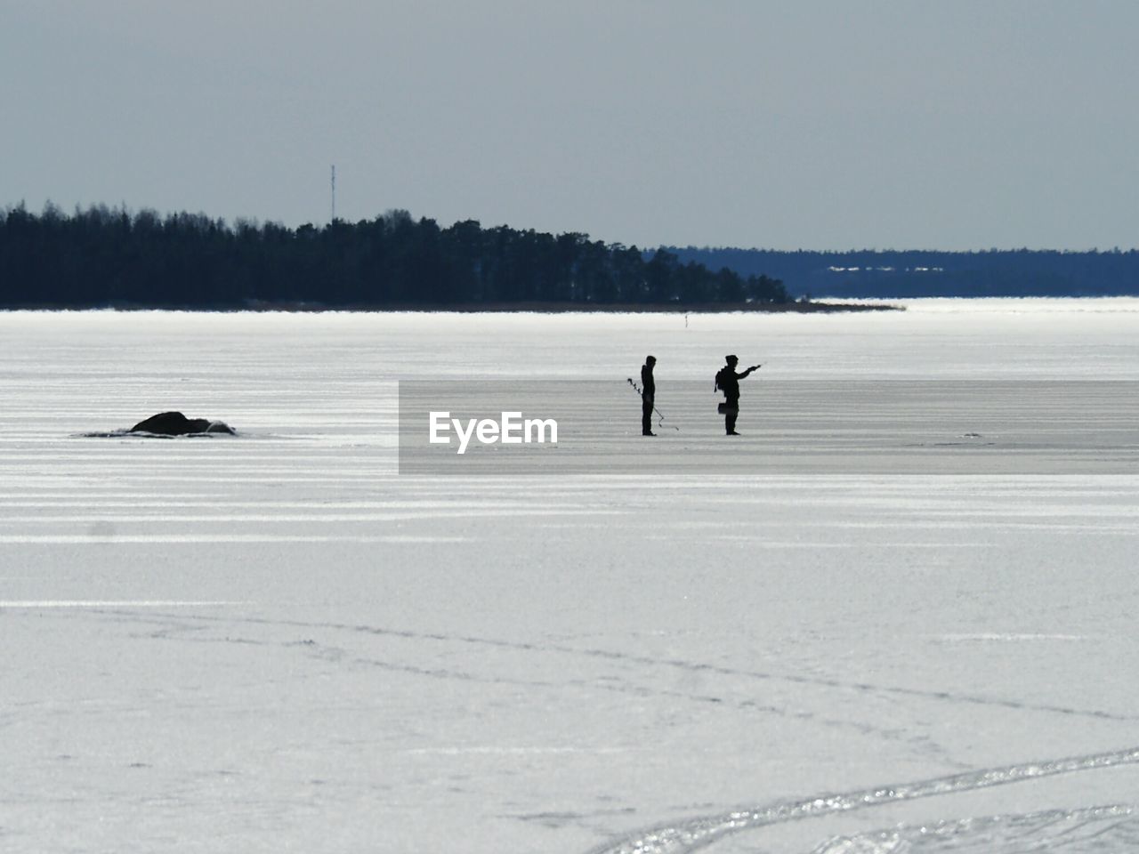 PEOPLE WALKING ON SNOW COVERED LAND